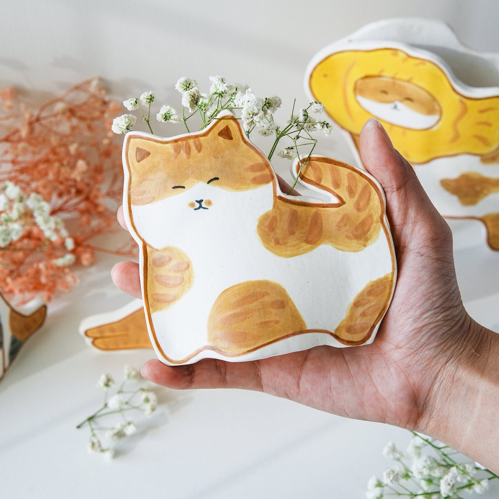 Keramik-Übertopf mit orangefarbener Katze